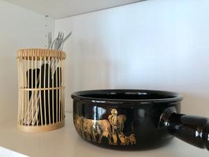 a black pot sitting on a counter next to a bird cage at Chalet Pironnet with BEST Views, Charm and Comfort! in Lauterbrunnen