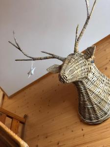 a sculpture of a deer head on a wall at Chalet Pironnet with BEST Views, Charm and Comfort! in Lauterbrunnen