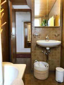 a bathroom with a sink and a tub and a mirror at Chalet Pironnet with BEST Views, Charm and Comfort! in Lauterbrunnen