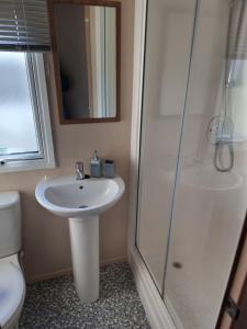 a bathroom with a sink and a shower at Summer Breeze in Bude