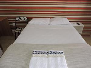 Cama o camas de una habitación en Pousada Novo Tempo