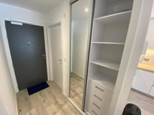 a walk in closet with a glass door at Modern Studio Apartment at The Hub in Gibraltar