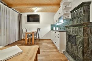 a kitchen with a table and a dining room at Kosodrzewina - apartamenty rodzinne in Bukowina Tatrzańska