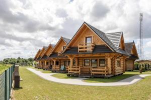 a large log cabin with a black roof at Holiday resort, Wicie in Wicie