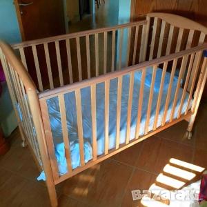 a wooden crib with blue sheets in a room at Metaxas Mansion in Kakopetria