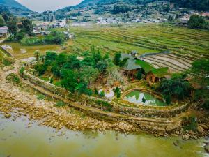 an aerial view of a village next to a river at Sapa Riverside Ecolodge & Spa in Sa Pa