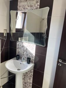 a bathroom with a sink and a mirror at En Passant / a time in Iasi in Iaşi +14 photos