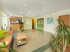 a living room with a couch and a table at Arabella Hotel in Kuressaare