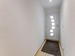 an empty room with a door and a rug at Beautiful cottage in La Chaux with jacuzzi in La Chaux