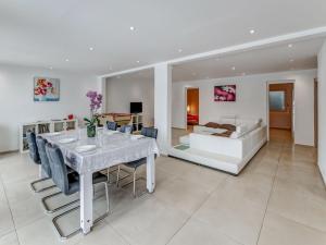 a living room with a white table and a couch at Beautiful cottage in La Chaux with jacuzzi in La Chaux