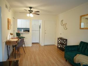 a living room with a green couch and a table at Cozy Condo near Buckhead in Atlanta