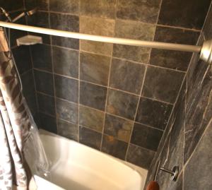 a bathroom with a bath tub and a shower curtain at Cozy Condo near Buckhead in Atlanta