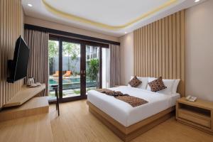 Ein Bett oder Betten in einem Zimmer der Unterkunft ABISHA Hotel Sanur