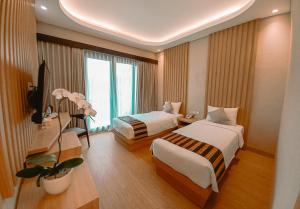 Ein Bett oder Betten in einem Zimmer der Unterkunft ABISHA Hotel Sanur