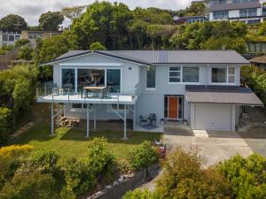 an aerial view of a blue house with a porch at Ocean Vista in Nelson