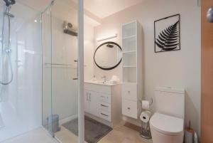 a bathroom with a shower and a toilet and a sink at Ocean Vista in Nelson +18 photos