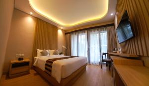 Ein Bett oder Betten in einem Zimmer der Unterkunft ABISHA Hotel Sanur