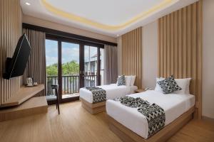 Ein Bett oder Betten in einem Zimmer der Unterkunft ABISHA Hotel Sanur