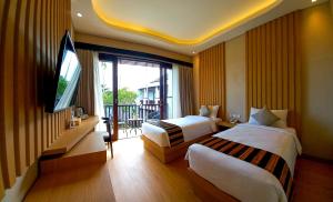 Ein Bett oder Betten in einem Zimmer der Unterkunft ABISHA Hotel Sanur