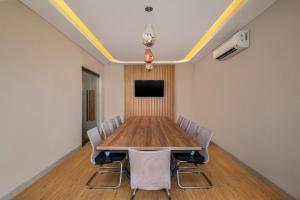 a conference room with a wooden table and chairs at ABISHA Hotel Sanur in Sanur