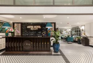 an art hotel lobby with a bar and a dining area at ARTIS Hotel Da Lat in Da Lat