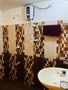 a bathroom with a sink and a shower at Thathsara Holiday Inn in Sigiriya