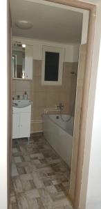 a bathroom with a bath tub and a sink at La Anda in Ruşca +16 photos