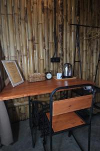 a wooden desk with a chair next to a wall at Sawah Ijen in Licin