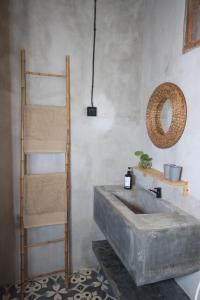 a bathroom with a large concrete sink and a ladder at Sawah Ijen in Licin