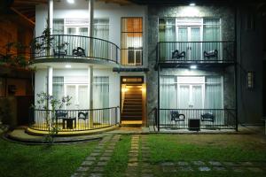 a building with two balconies and a door at night at Ella moon rock in Ella
