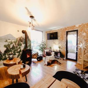 a living room with a dog laying on the floor at Bieszczadzkie BOHO stodoły z jacuzzi i sauna na wyłączność in Myczkowce