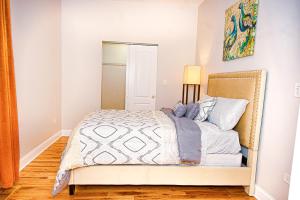 a bedroom with a bed and a mirror at Lux Apt in Bronzeville, Min from Downtown-RSV Now! in Chicago