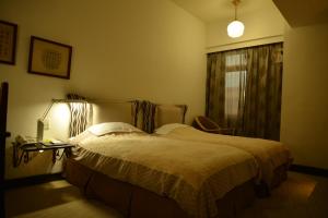 Postel nebo postele na pokoji v ubytování Kingship Hotel Kaohsiung Inter Continental