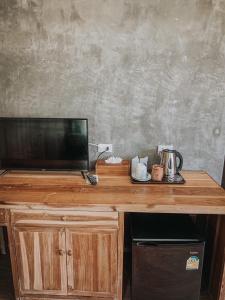 a wooden desk with a television on top of it at Koh Yao Beach Front in Ko Yao Yai