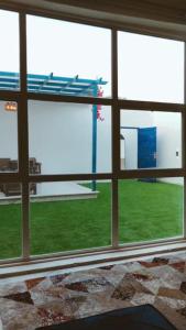 a room with a window with a view of a field at Altaraf Resort in Al Shafa +11 photos