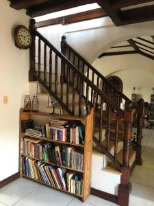 a staircase with a book shelf filled with books at THEE VIEW in Hartbeespoort