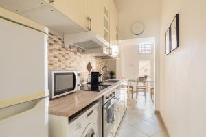 a kitchen with a counter top with a tv on it at Residenza Piazza di Spagna in Rome