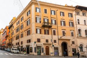 a large yellow building on a city street at Residenza Piazza di Spagna in Rome