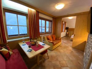 ein Wohnzimmer mit einem Tisch und einem Sofa in der Unterkunft Appartement Gafluna in Sankt Anton am Arlberg