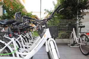 a row of white bikes parked next to each other at Aparthotel Gioia in Caorle