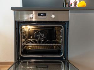 an oven with its door open in a kitchen at Uppsala Hotel Apartments in Uppsala