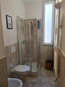 a bathroom with a shower and a toilet and a sink at FLORENCE QUARTERS in Florence