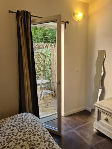 a bedroom with a door leading to a patio at FLORENCE QUARTERS in Florence