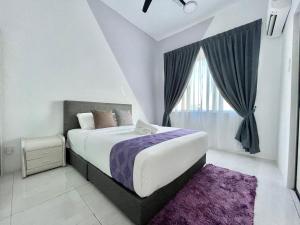 a bedroom with a large bed and a window at Langkawi Simfoni Beliza Apartment with Sky Pool by Zervin in Kuah