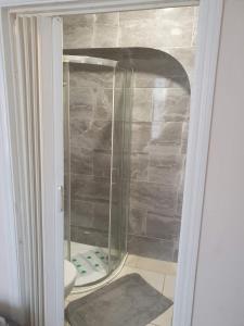 a shower with a glass door in a bathroom at En suite bedrooms, Heaton, Newcastle in Newcastle