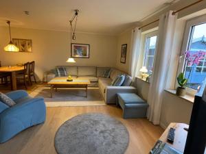 a living room with a couch and a table at Meine Ferienwohnung in Fehmarn