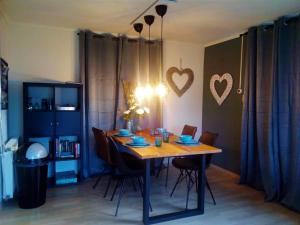 a dining room with a wooden table and chairs at Het Dobbertje, charmant houten huisje in Sint Maartensvlotbrug
