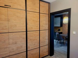 a wooden sliding door in a room with a table at Apartament LOFTSPA in Ustrzyki Dolne