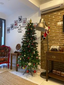 a christmas tree in a living room with a fireplace at The Print House Hotel in Istanbul
