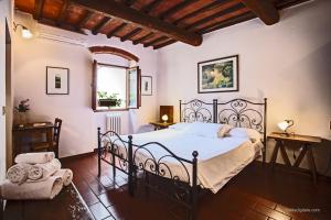 a bedroom with a black bed and a window at Tenuta Il Burchio in Incisa in Valdarno